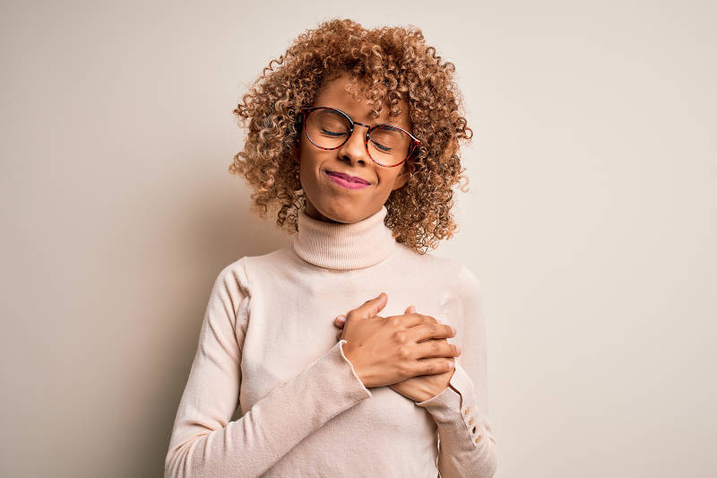 woman with hands on her chest